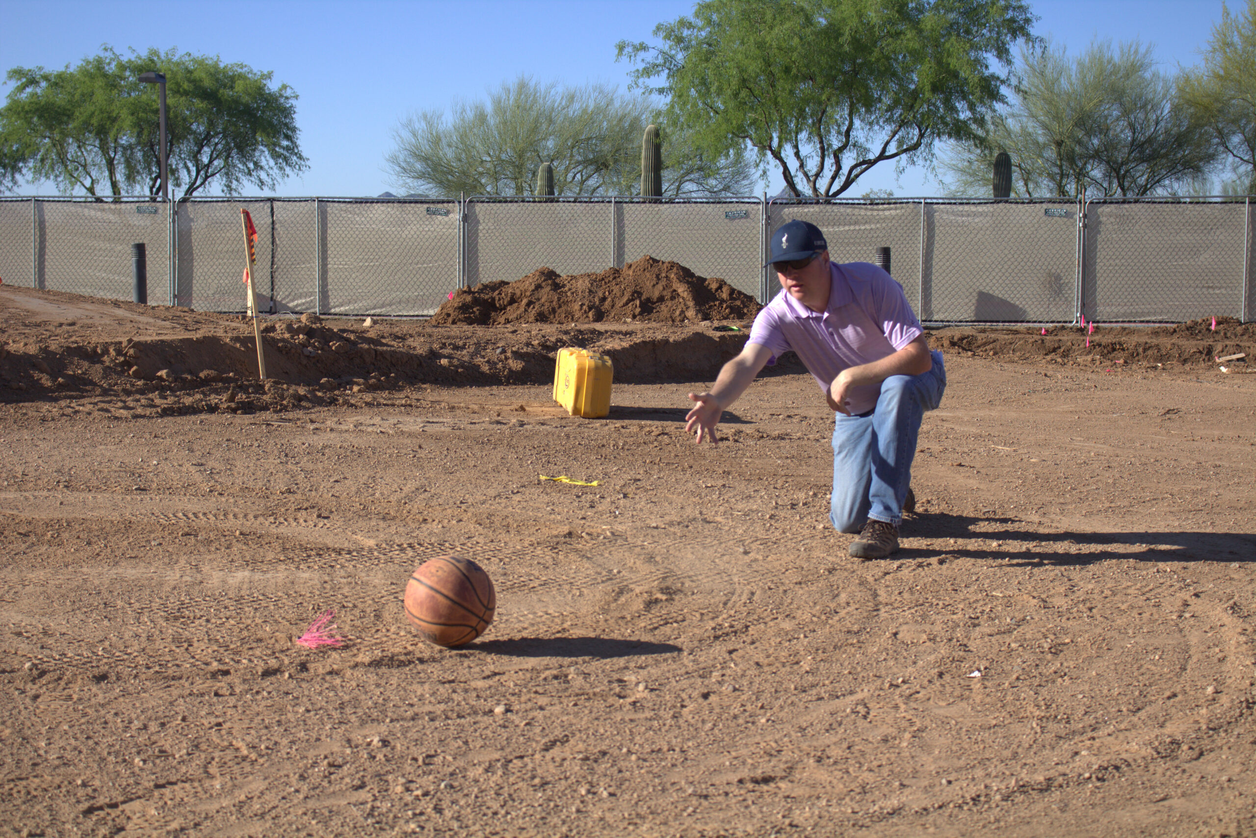 Gary Brawley rolling a basketball on a golf course that is being developed