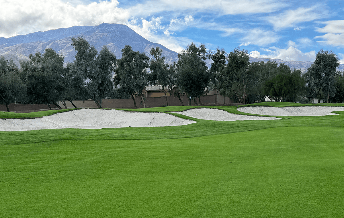 Golf course fairway at Trilogy featuring multiple sand bunkers