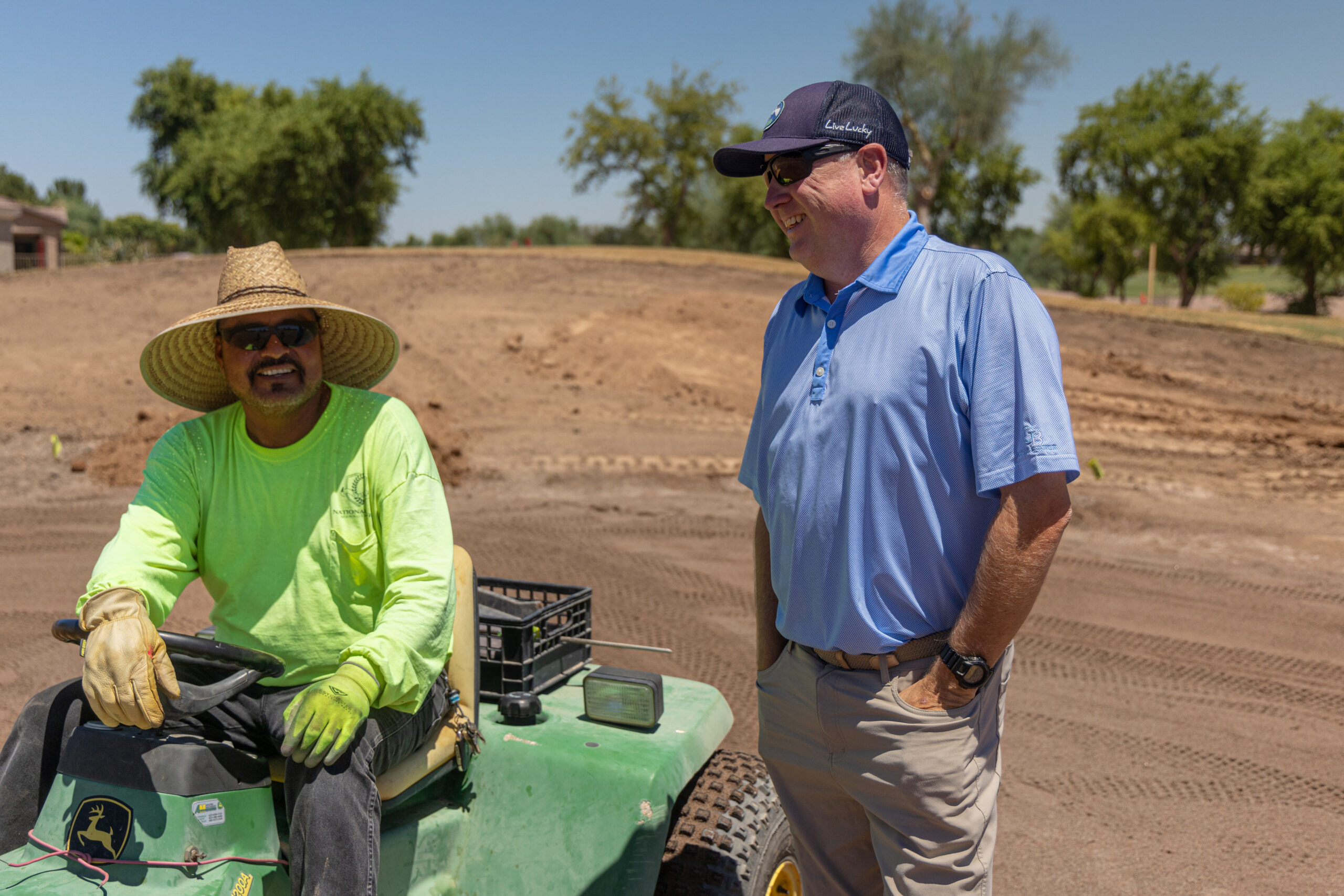 Gary Brawley and construction crew member discussing green renovation work at Power Ranch Golf Club