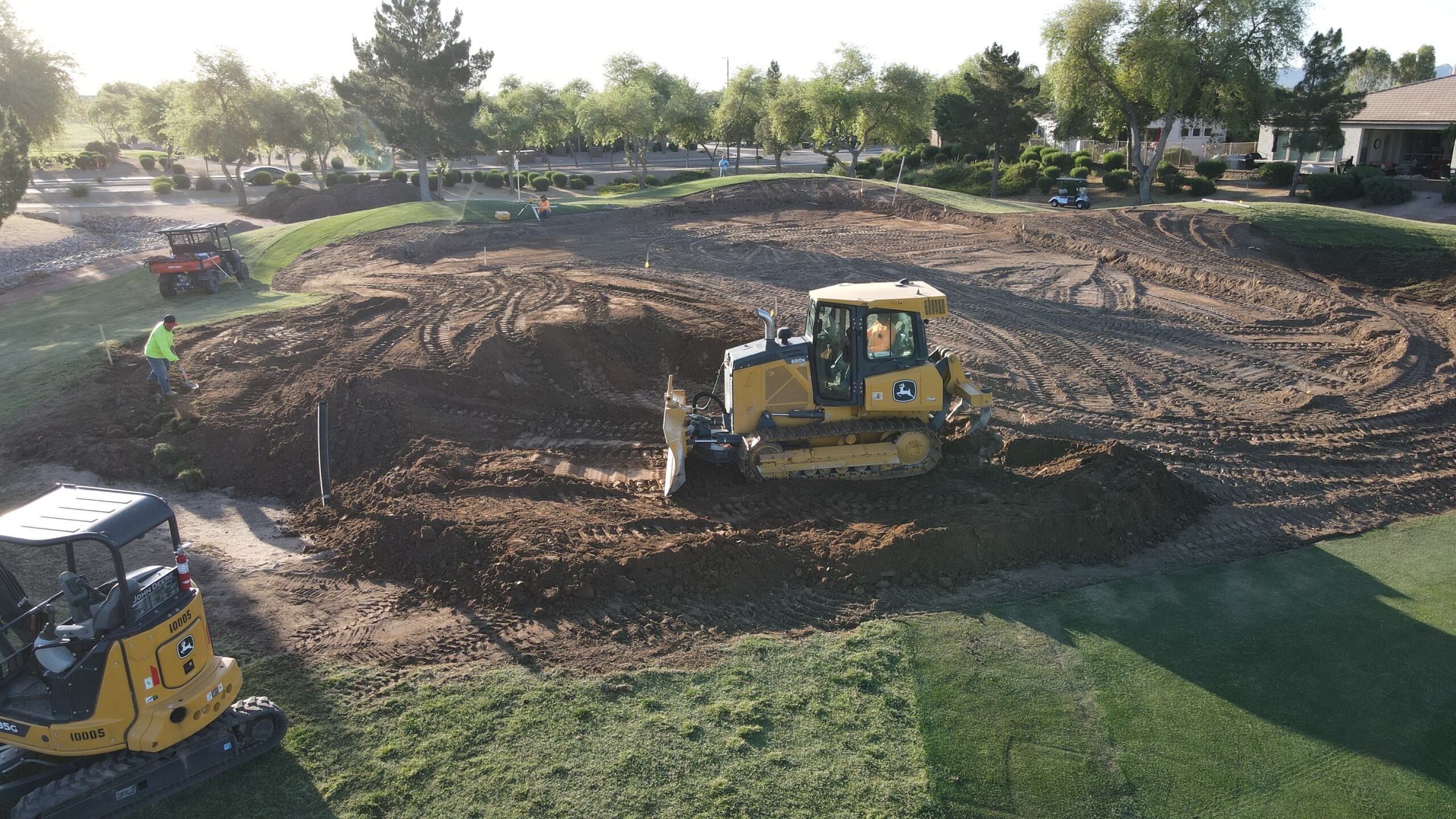 Golf course green reconstruction at Power Ranch Golf Club with bulldozers shaping contours during renovation work